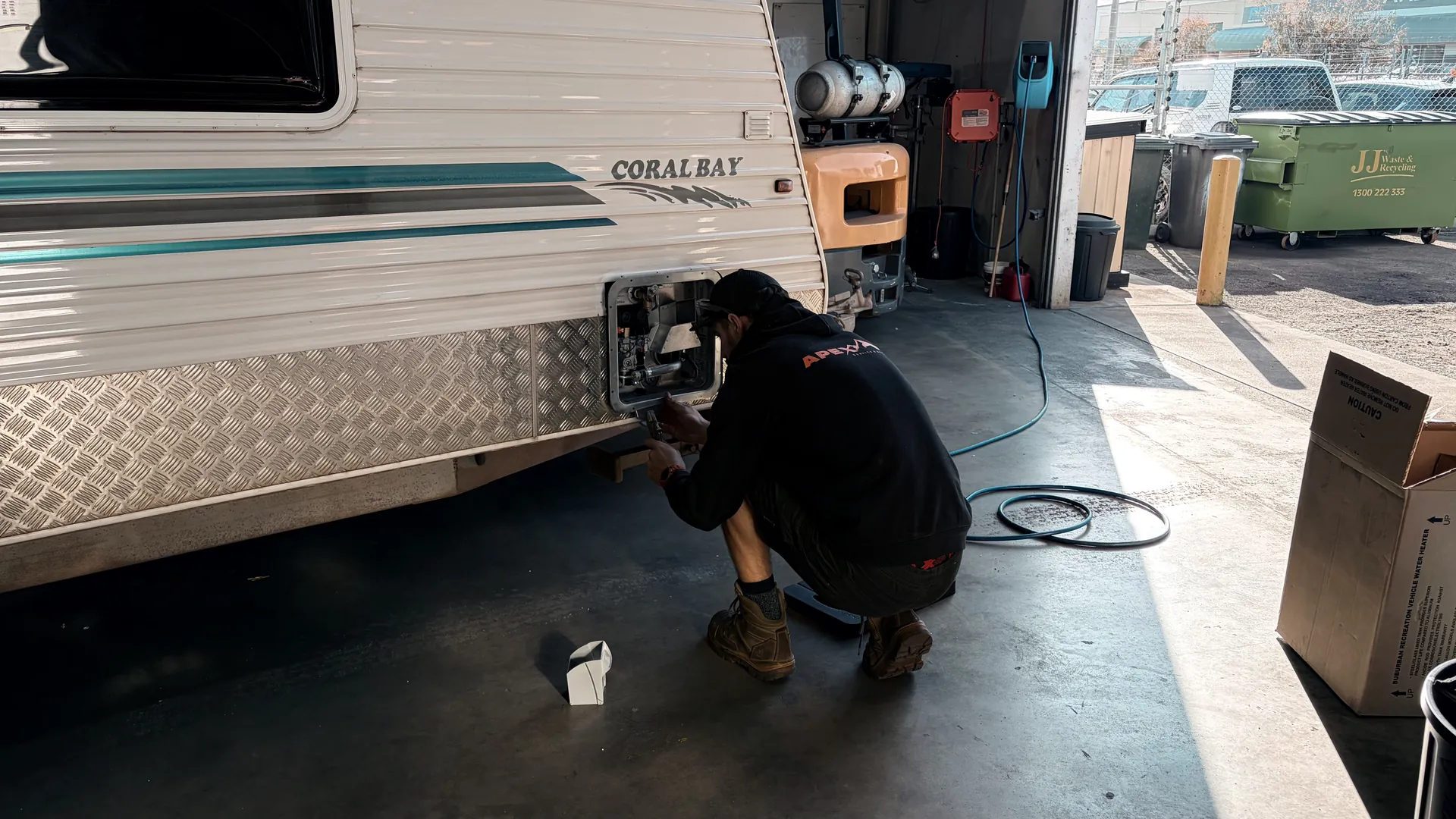 Apex technician carrying out a warranty repair at a caravan’s external service hatch