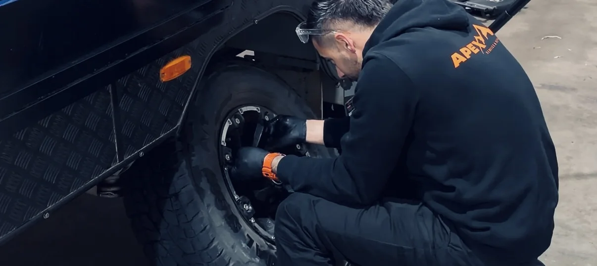 Mark servicing Jayco caravan wheel at Apex workshop