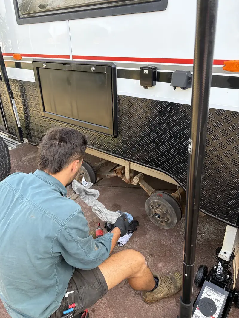 Apex technician servicing caravan brake hub